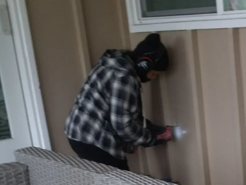 Professional electrician installing an exterior outlet in Dunn